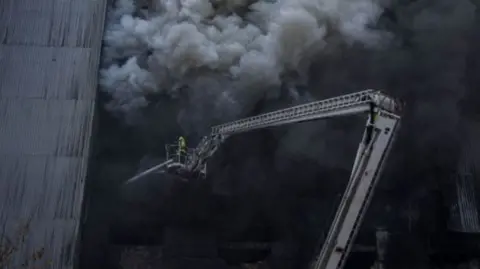 A firefighter tackles a fire