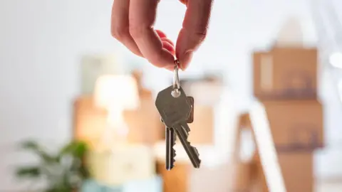 Getty Images Hand holding two keys