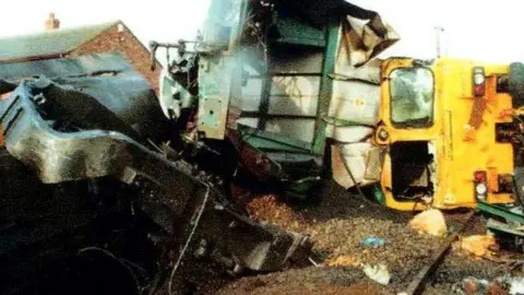 PA Media/NorthYorkshire Police handout A Freightliner engine lies on its side after the impact collision with a passenger express 