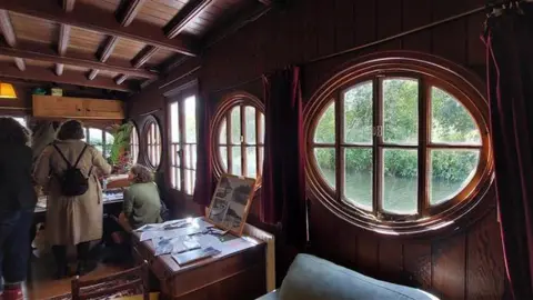 Inside the Corpus Christi Barge during their open days in September. The oval windows that the trust says have inspired Tolkien for his sketches of Bag End can be seen.