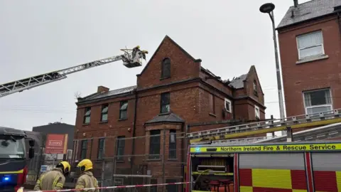 A fire appliance being used to fight the fire in the affected building  