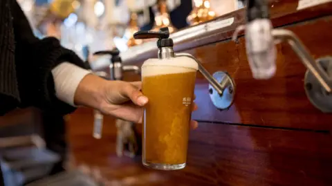 Getty Images A pint of beer being pulled from a pump in a bar. 