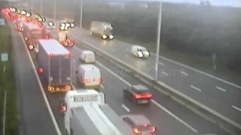 CCTV FOOTAGE of a motorway showing tailbacks of lorries vans and cars