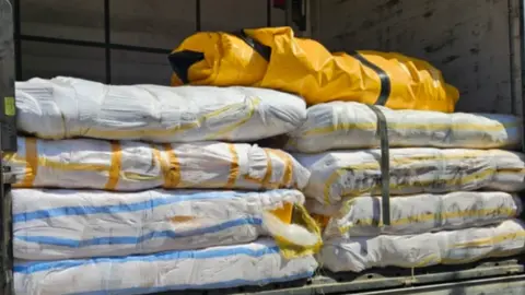 NCA Several inflatable boats are stacked up in the back of a lorry that has been stopped in Bulgaria.