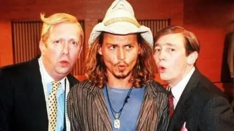Mark Williams, Johnny Depp and Paul Whitehouse in the suits you sketch from the Christmas 2000 special - Williams and Whitehouse are in their black suits, Depp wears a Stetson hat, a striped shirt and a blue T-shirt. They are all making an "Oooh" face.