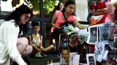 Reuters People gather outside the hotel where Liam Payne, former One Direction band member, was found dead after he fell from a third-floor hotel room balcony, in Buenos Aires.