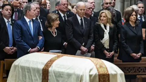Reuters Former President George Bush, his wife Laura Bush, former President Joe Biden, his wife Jill Biden, and former Vice President Kamala Harris stand in a pew 