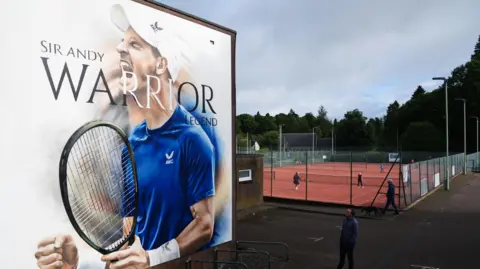 PA Media A 20ft mural of Andy Murray holding a tennis racket pinch his hands grasped and rima opens. It sounds Sir Andy, warrior, legend.