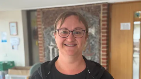 George King/BBC A head and shoulders image of Laura Brockwell. She is wearing glasses and looking into the camera.