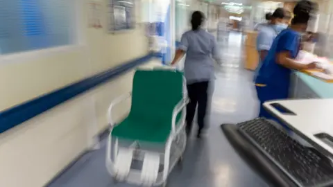 PA File photo of a general view of staff on a NHS hospital ward 