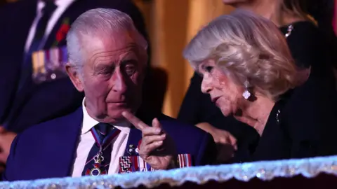 PA Media The King and Queen sit in the royal box at the Royal Albert Hall.