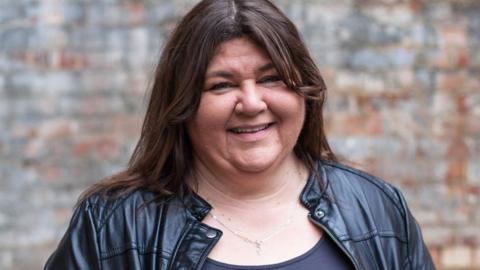 Cheryl Fergison smiles for the camera as she waits to find out which household she will be living with as part of the 'Famous, Rich and Hungry' series for sport relief 2014 in London, England