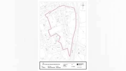 Gateshead Council A white and black map of Gateshead town centre which has a red line around an area in the centre of it.