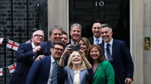 EPA West Yorkshire Mayor Tracy Brabin takes a selfie with 9 other regional mayors, including Kim McGuinness and Ben Houchen, on the steps of 10 Downing Street. 