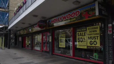 The Hollywood Just for Fun fancy dress shop outside with signs up saying "Sale" and "50% off"