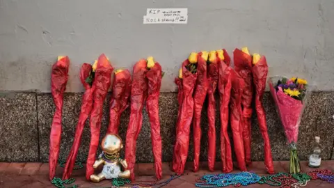 EPA-EFE/REX/Shutterstock Flowers placed at the entrance of Bourbon Street. 