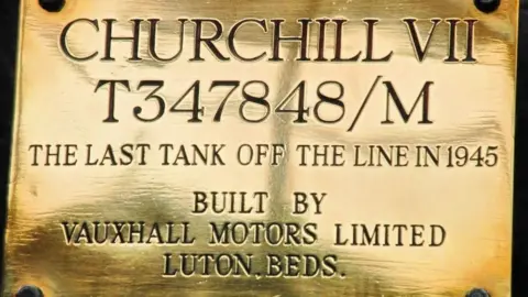 Tank Museum A brass plate depicting the name and serial number of the last Churchill tank to come off the production line at Vauxhall Motors Limited in Luton in 1945