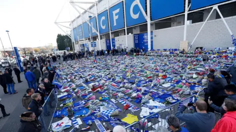 Reuters Flowers, balloons and cards left outside the King Power Stadium in 2018