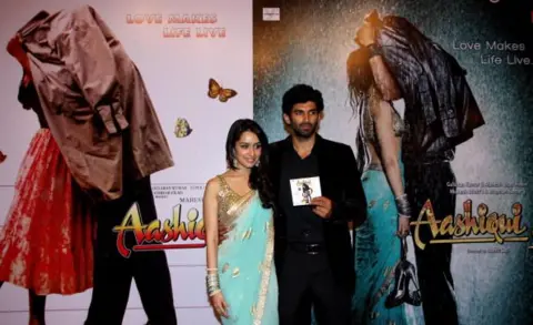 AFP via Getty Images Indian Bollywood actors Shraddha Kapoor (L) and Aditya Roy Kapoor attend a soundtrack launch event for the forthcoming Hindi Film "Aashiqui 2" in Mumbai on April 8, 2013. 
