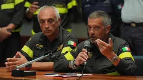 PA Girolamo Bentivoglio Chief of the Palermo fire brigade (right) speaking during a press conference at the Tribunale building in Termini Imerese, Sicily on the search and recovery operation after the luxury yacht Bayesian sank in a storm on Monday whilst moored around half a mile off the coast of Porticello, Sicily. Picture date: Saturday August 24, 2024. 