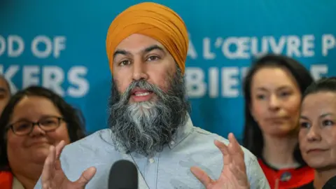 Getty Images Canada's NDP leader, Jagmeet Singh, speaks to the media after delivering a keynote at the Canadian Labour Congress (CLC) Political Action Conference, held at Edmonton's Chateau Lacombe Hotel on February 20, 2025