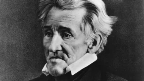 Library of Congress/Getty Images A black and white archive image of US President Andrew Jackson. He had short, wavy grey hair and is wearing a black suit and a white shirt with a high collar. 