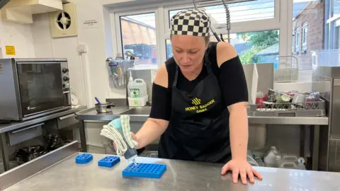 Catherine putting jelly in sweet mould