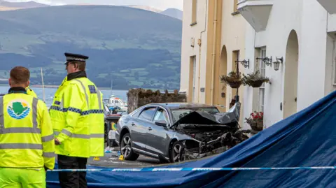 Rob Formstone Freelance Photos North Wales The accident scene in Alma Street with a badly damaged Audi near houses and emergency services, including police, near a plan around the accident scene