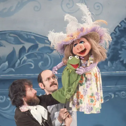 Getty Images Jim Henson and Frank Oz operate Kermit and Miss Piggy puppets on stage at Elstree Studios