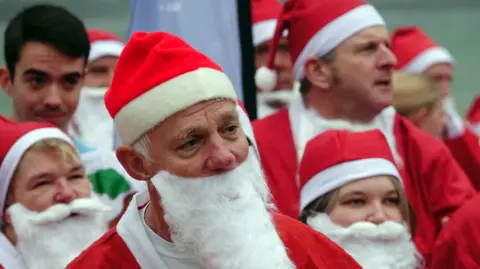 Kevin Frampton A close up of runners dressed as Santas before the run started