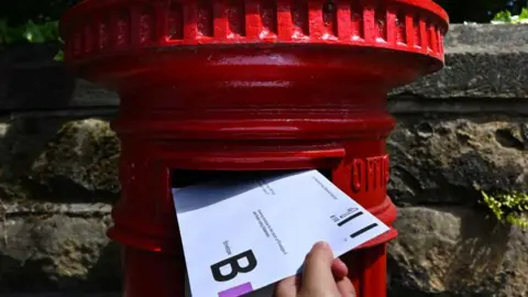 Getty Images Person posting postal vote