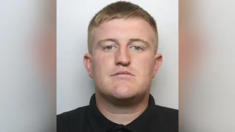 South Yorkshire Police A mugshot of Whitehead, who has short blond hair, a seemingly broken nose and no facial hair.