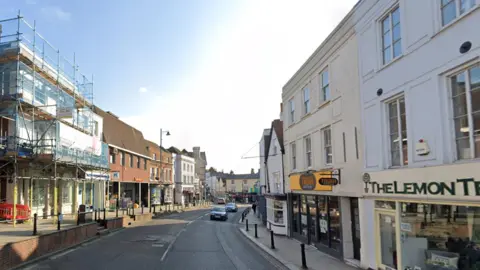 A view of Dorking High street, showing shops and houses