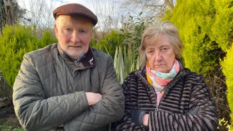 BBC Claudette Charley and her husband Brian in their back garden
