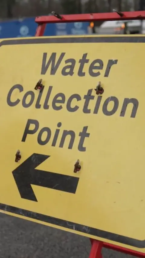 A sign advertising a water collection point.