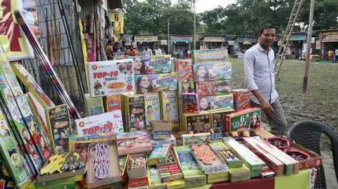 Getty Images A man walks past a stall at a firecracker fair ahead of the Diwali in Kolkata, on October 29, 2024