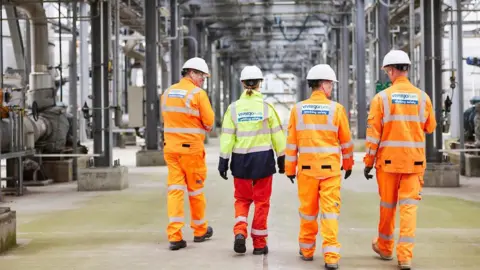 Vivergo Four Vivergo workers wearing hi-viz outfits walking in front of machinery at the bioethanol plant in Hull