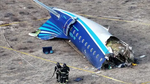 A drone view shows rescuer workersat the crash site of an Azerbaijan Airlines passenger plane on 25 December