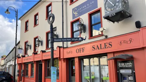 A bar and off-sales in Dromore which has been painted a nice russet colour as part of the town's revitalisation project