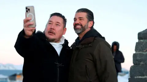 Donald Trump Junior poses for a selfie with a Greenland resident during his visit to Greenland