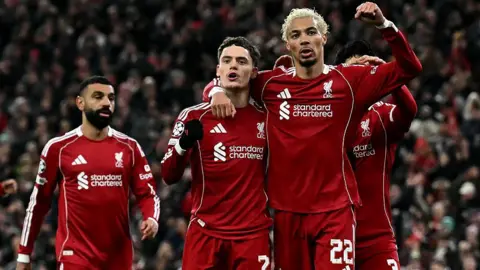 Liverpool midfielder Florian Wirtz celebrates scoring a goal with Hugo Ekitike