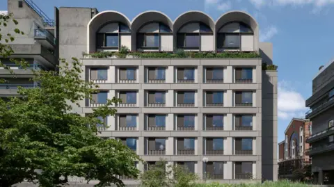 City of London Corporation handout A computer-generated image of apartment windows in the building, with those on the top floor featuring arch details on the side elevation of the building