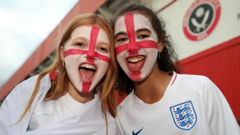 PA Media Two girls with face paint