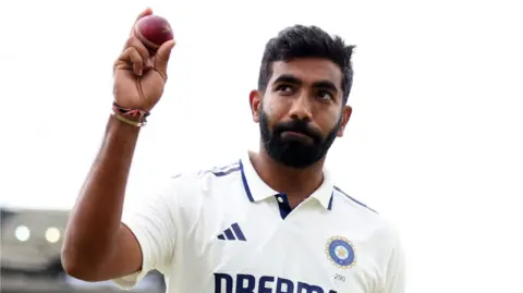 India fast bowler Jasprit Bumrah holds up the ball to the crowd after taking five wickets against England