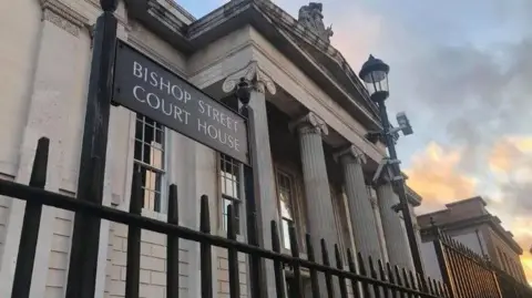 BBC Bishop Street Courthouse is seen in the sunshine.
A number of clouds can be seen in the background of the building