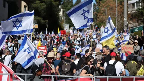 EPA Wide angle view showing a protest in Jerusalem. People are seen holding signs and Israel flags