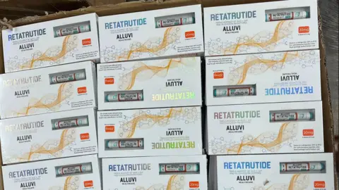 MHRA A cardboard box contains packaging with the words "Retatrutide" and the branding "Alluvi Healthcare".