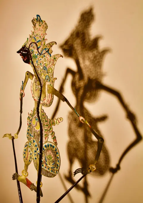 Jane Luetkens An Indonesian shadow puppet casting a shadow on the wall