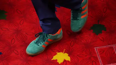 Reuters Justin Trudeau's red-striped green trainers, on a bright red carpet