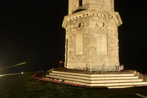 Reg Connon Standing poppies around Macduff's war memorial